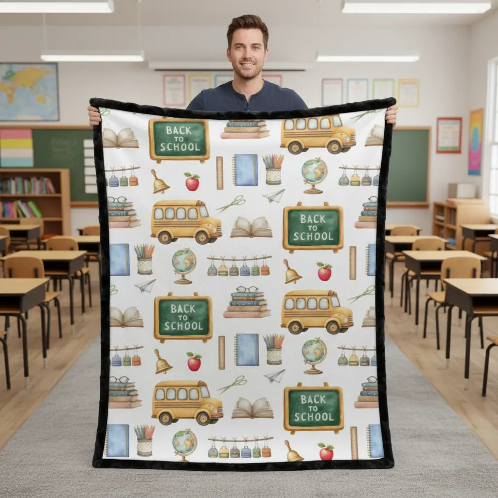 Person holding a 'Back to School' themed blanket in a classroom setting