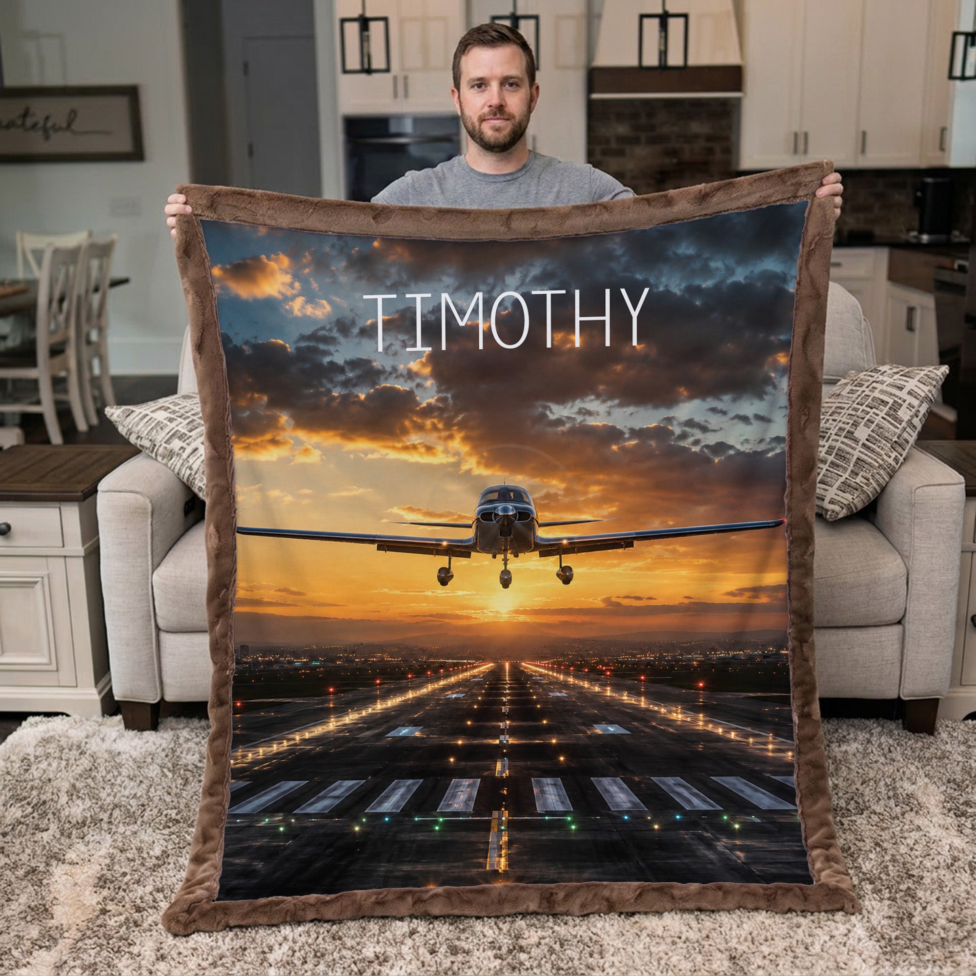 Personalized airplane photo blanket with brown faux fur border, held by man in living room