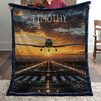 Personalized airplane photo blanket with navy faux fur border, held by woman near brick fireplace