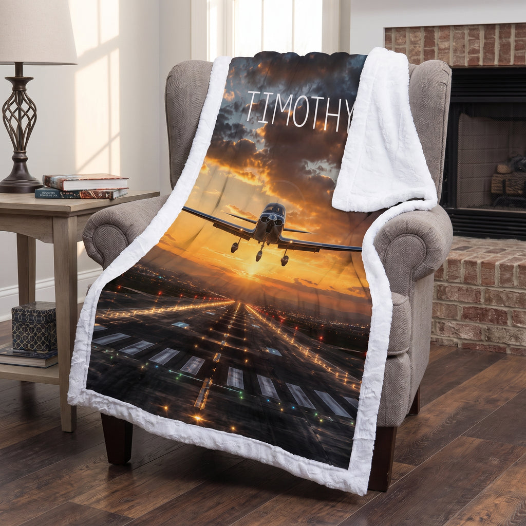 Personalized airplane photo blanket with white faux fur border, draped over armchair by fireplace