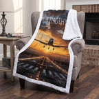 Personalized airplane photo blanket with white faux fur border, draped over armchair by fireplace