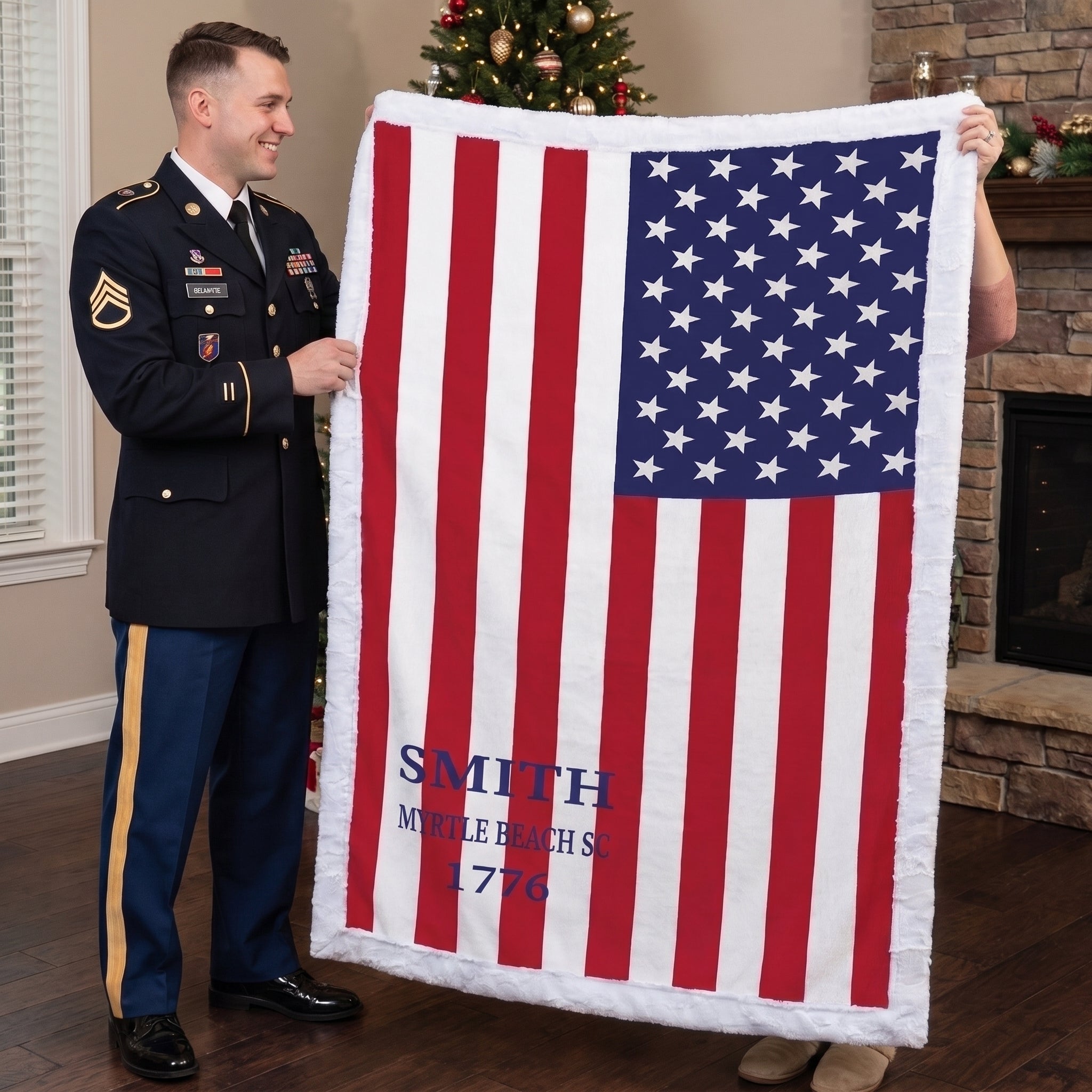 Personalized American flag blanket with family name held by soldier and woman near Christmas tree