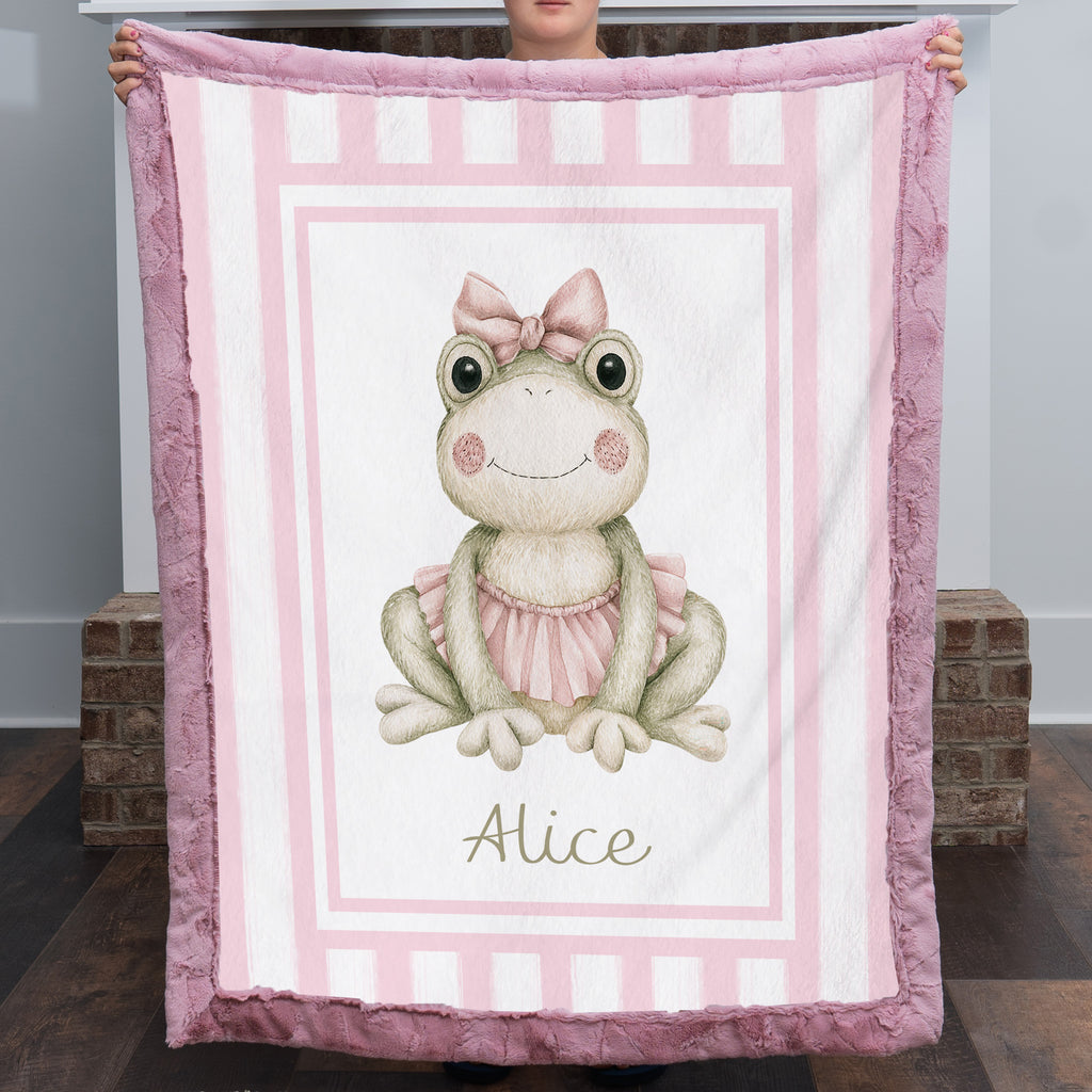 Personalized minky ballerina frog baby blanket with mauve pink fur border by fireplace