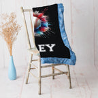 Close-up of personalized baseball minky blanket draped over vintage chair with blue trim