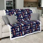 Baseball-themed blanket with 'Zachary' printed on a couch in a living room.