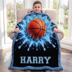 Boy holding personalized basketball blanket with custom name, sitting in armchair by window