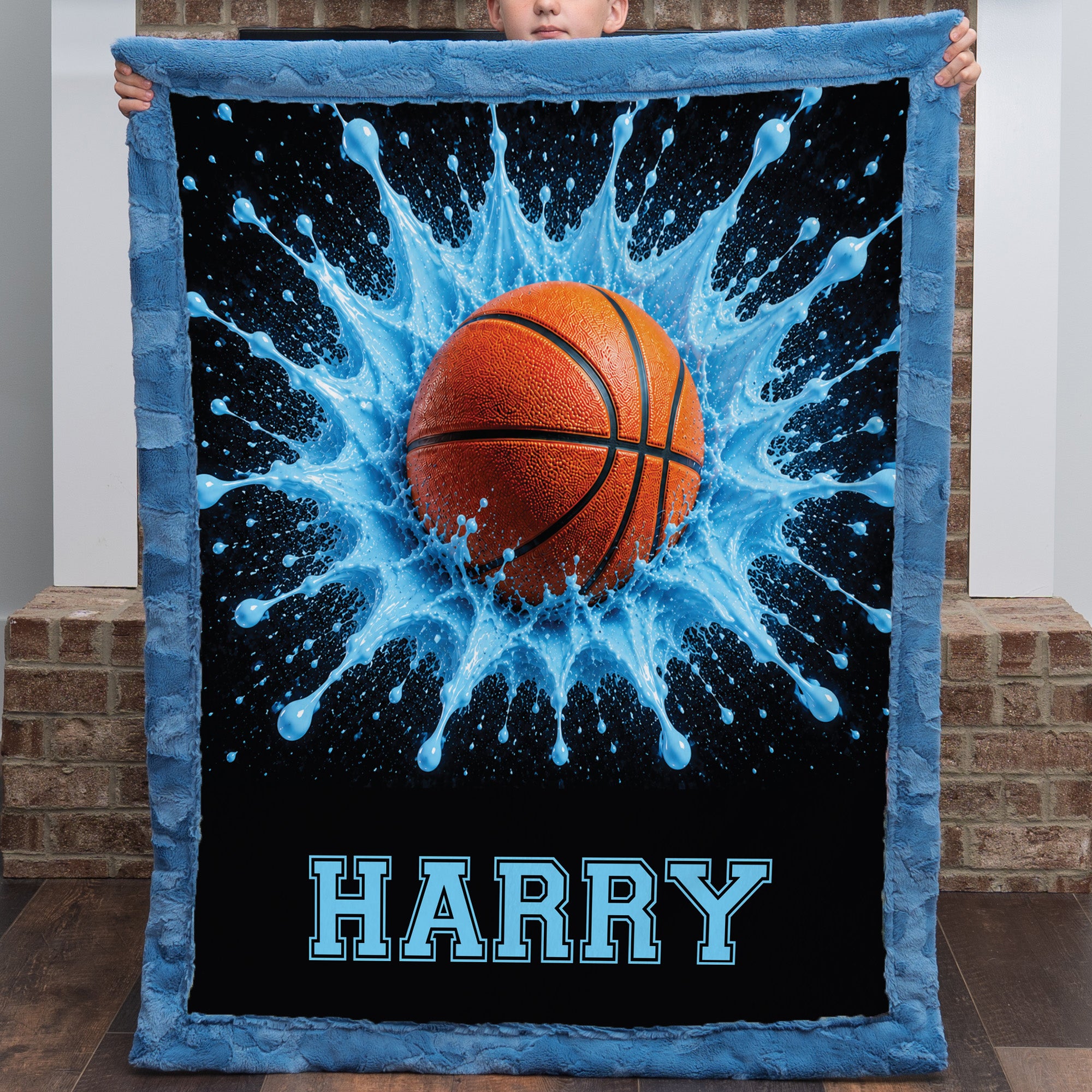 Close-up of boy holding personalized basketball blanket with custom name, blue faux fur trim