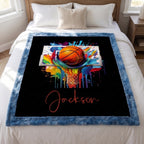 Personalized basketball Luxe Cuddle blanket laid flat on bed, colorful hoop art and name on black background