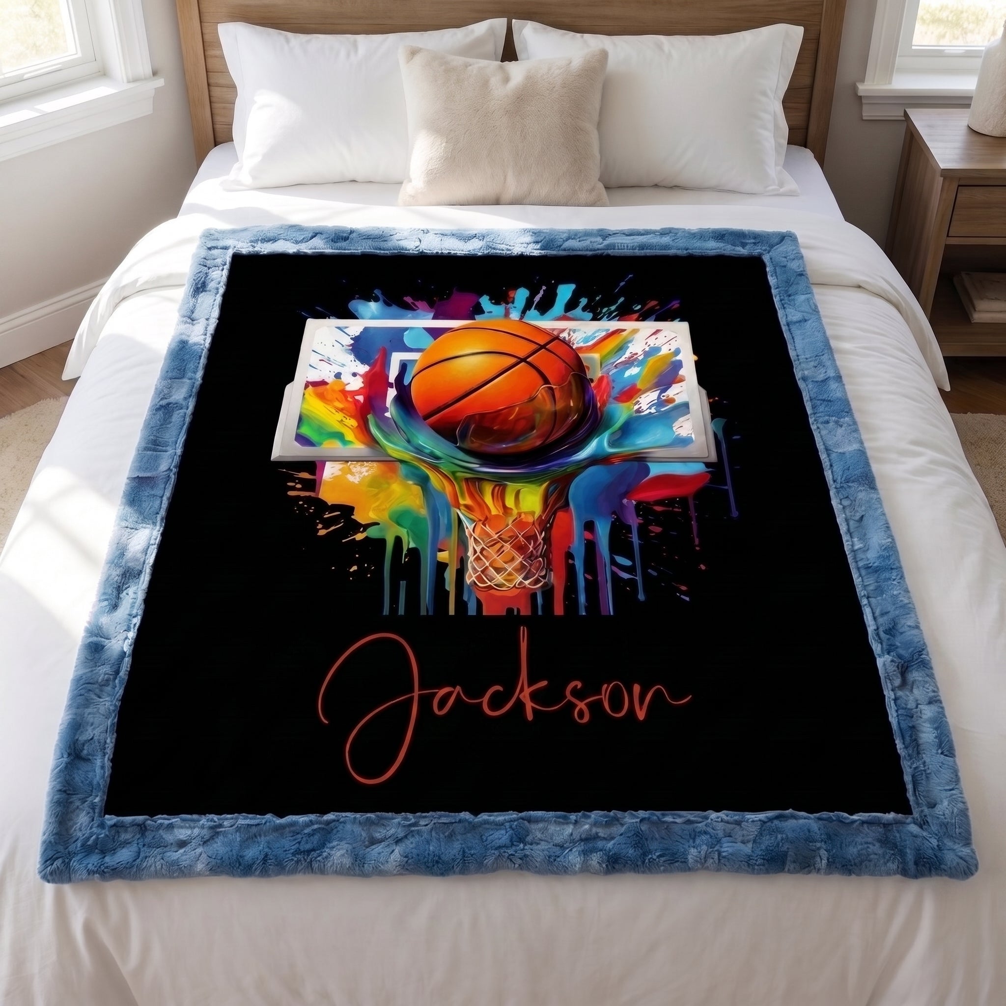 Personalized basketball Luxe Cuddle blanket laid flat on bed, colorful hoop art and name on black background