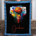 Personalized basketball Luxe Cuddle blanket held up, black background with colorful hoop art and name in script