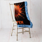 Close-up of personalized basketball minky blanket draped over vintage chair with blue trim