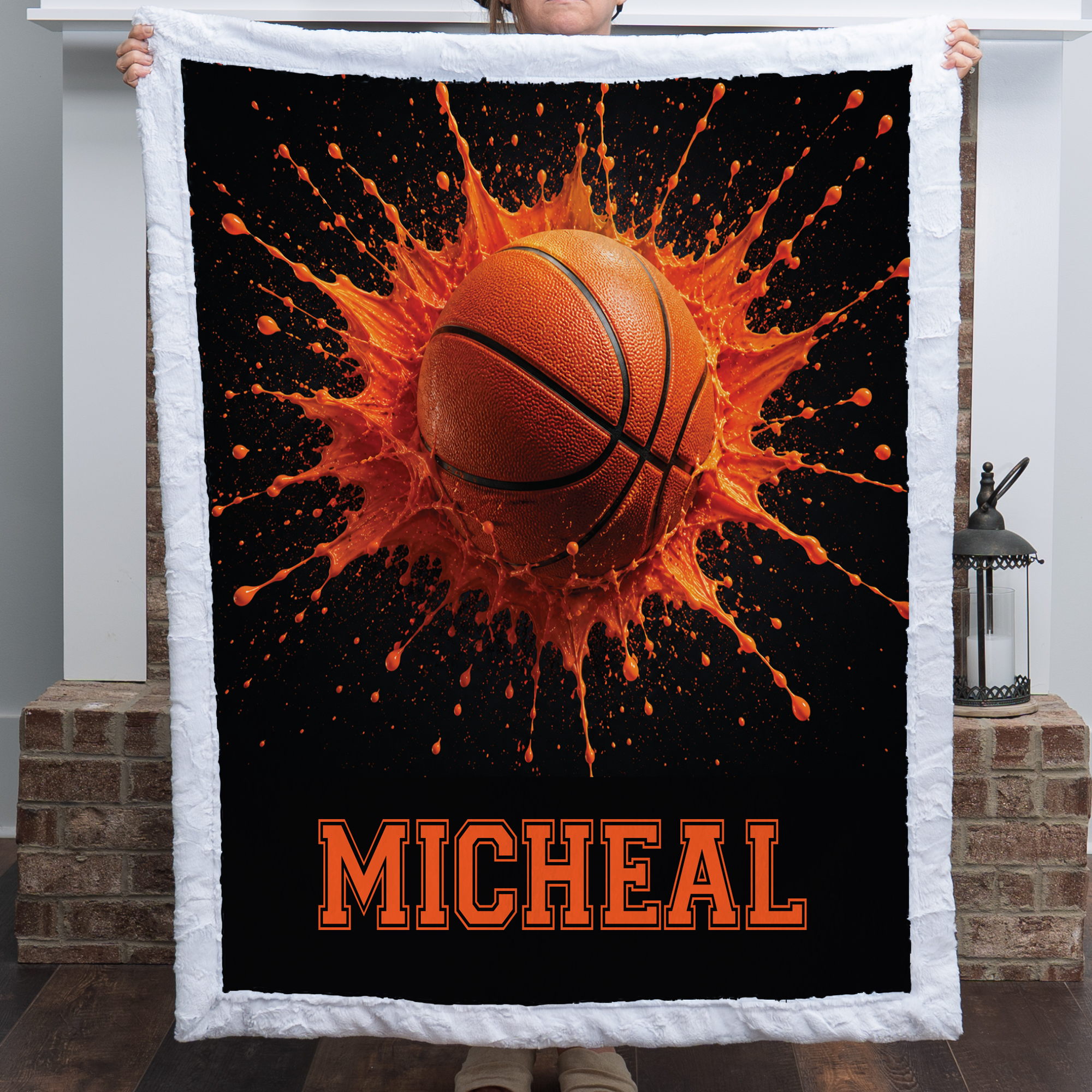 Personalized basketball minky blanket with white trim and custom name, by a brick fireplace