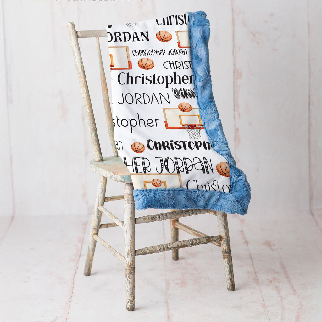 Personalized basketball name blanket with blue faux fur trim draped over rustic chair