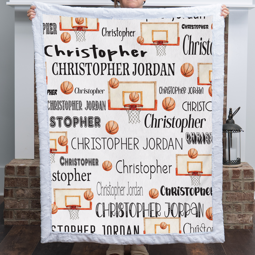 Woman holding personalized basketball name blanket with white faux fur trim by fireplace