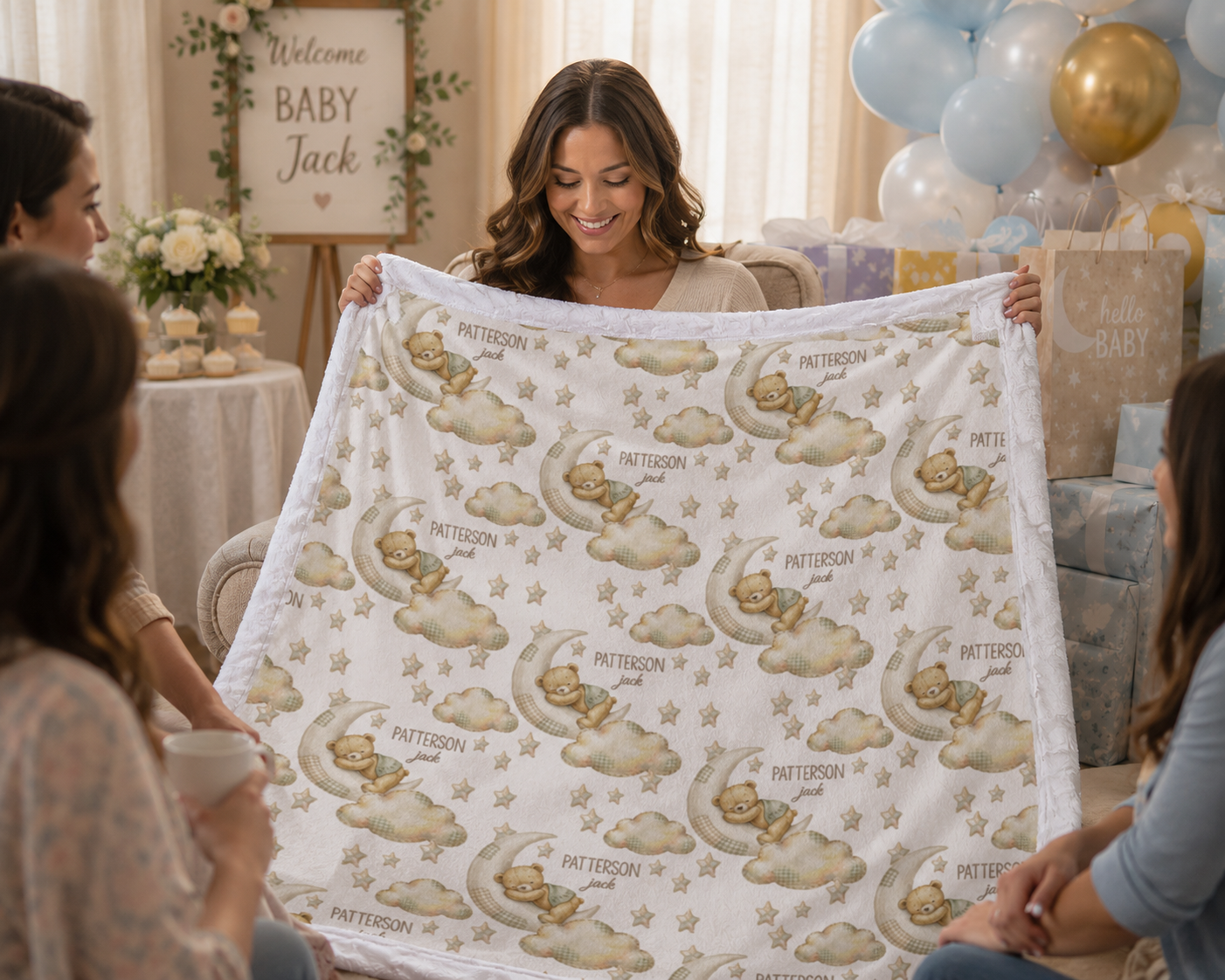 Guests admiring personalized bear and moon baby blanket with white trim at baby shower