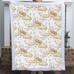 Woman holding personalized bear and moon baby blanket with white minky trim by fireplace