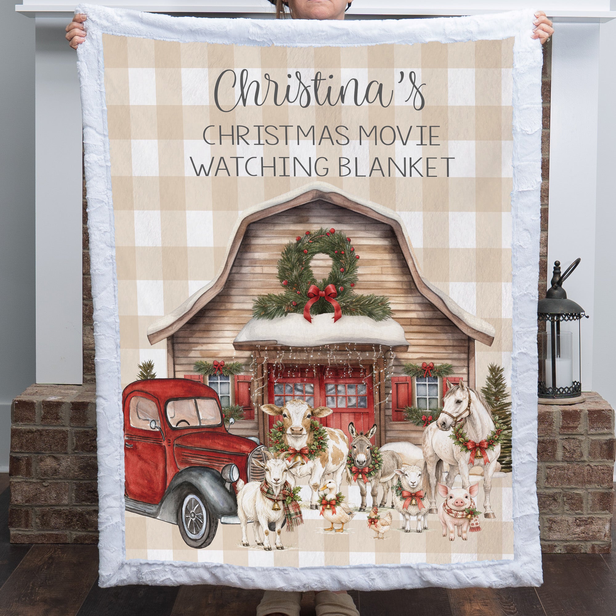 Woman holding personalized Christmas farmhouse minky blanket with white trim indoors