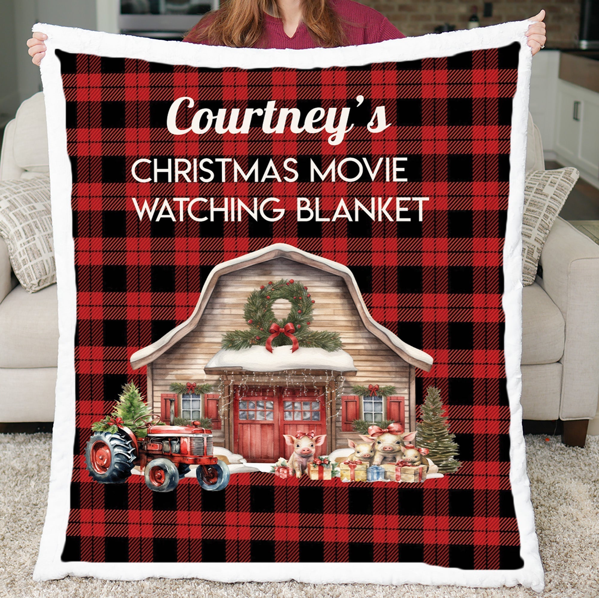 Personalized red buffalo plaid Christmas movie watching blanket held up, showing farm barn scene with faux fur border