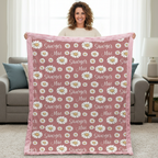 Woman holding personalized daisy minky blanket with pink trim indoors