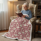 Woman reading in armchair with personalized daisy minky blanket, white sherpa back