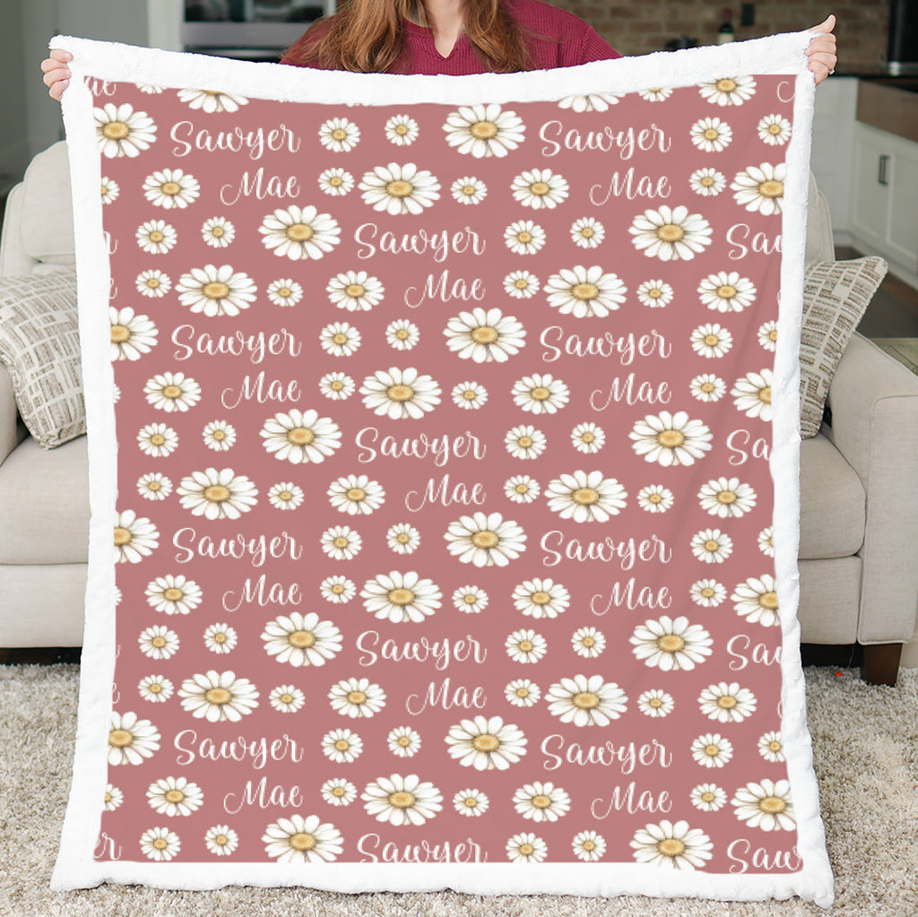 Woman holding personalized daisy minky blanket with white sherpa back