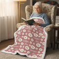 Woman reading with personalized daisy minky blanket, white sherpa back, on her lap