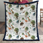 Personalized dinosaur minky baby blanket with navy trim and custom name, held by a woman