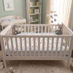 Personalized minky donkey baby blanket with blue fur border laid flat in nursery crib