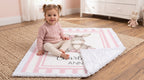 Toddler sitting on personalized minky donkey baby blanket on nursery rug