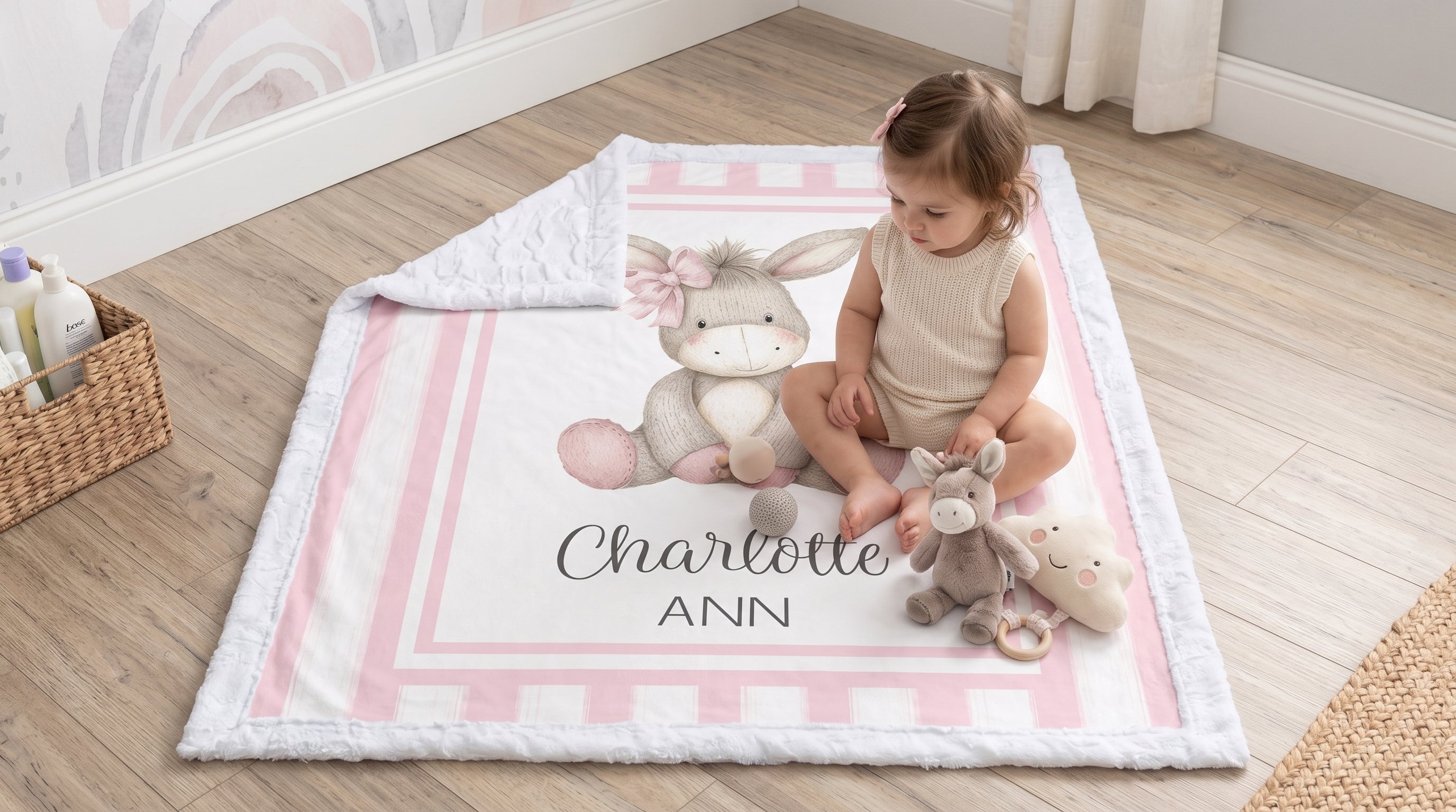 Toddler playing with donkey plush toy on personalized minky baby blanket