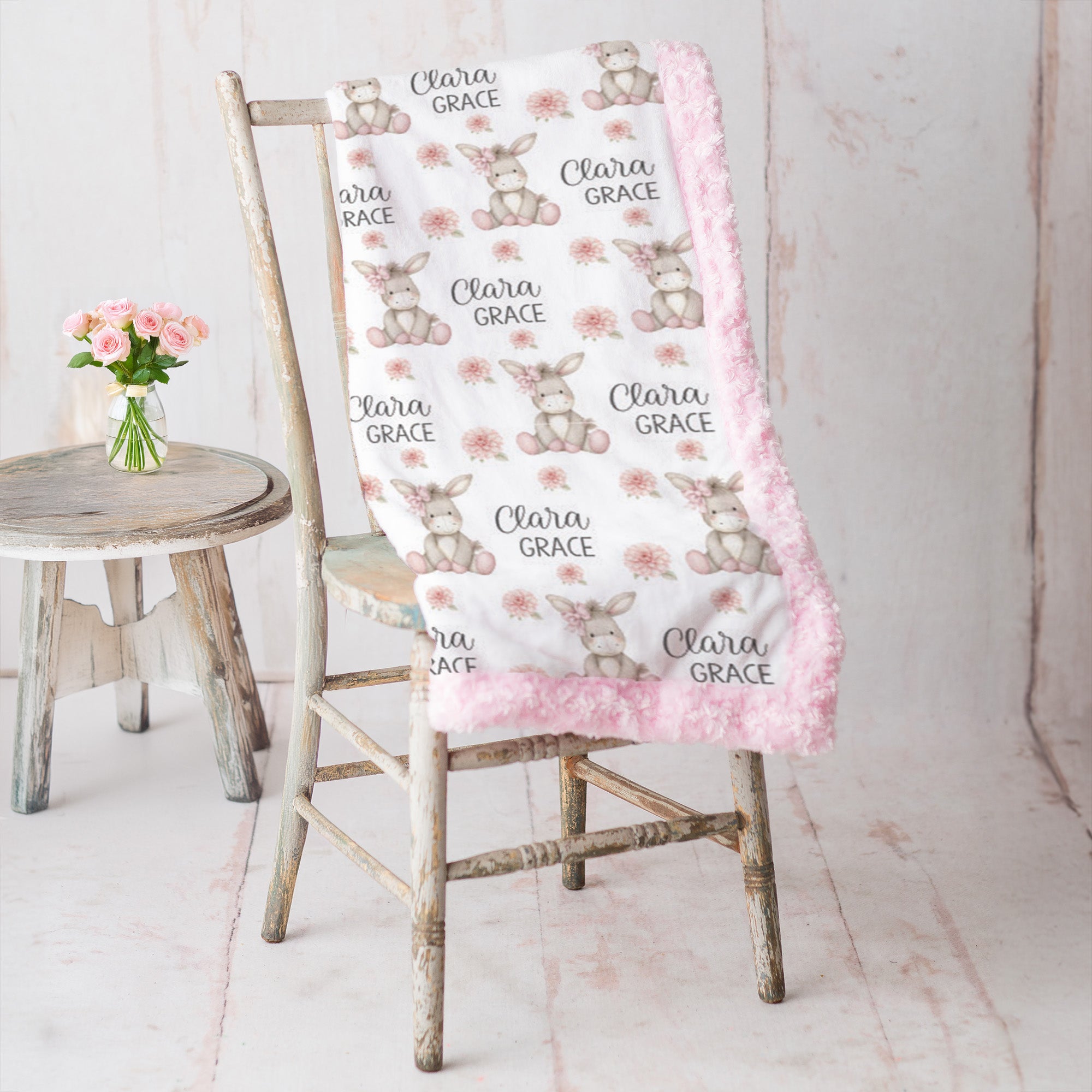 Personalized minky donkey baby blanket with pink rosette fur border on vintage chair