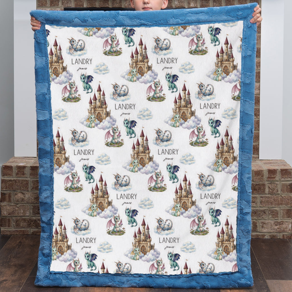 Boy holding personalized dragon castle blanket with blue trim