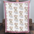 Woman holding personalized elephant baby blanket with pink minky trim indoors