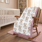 Personalized elephant baby blanket with pink minky trim draped over nursery rocking chair