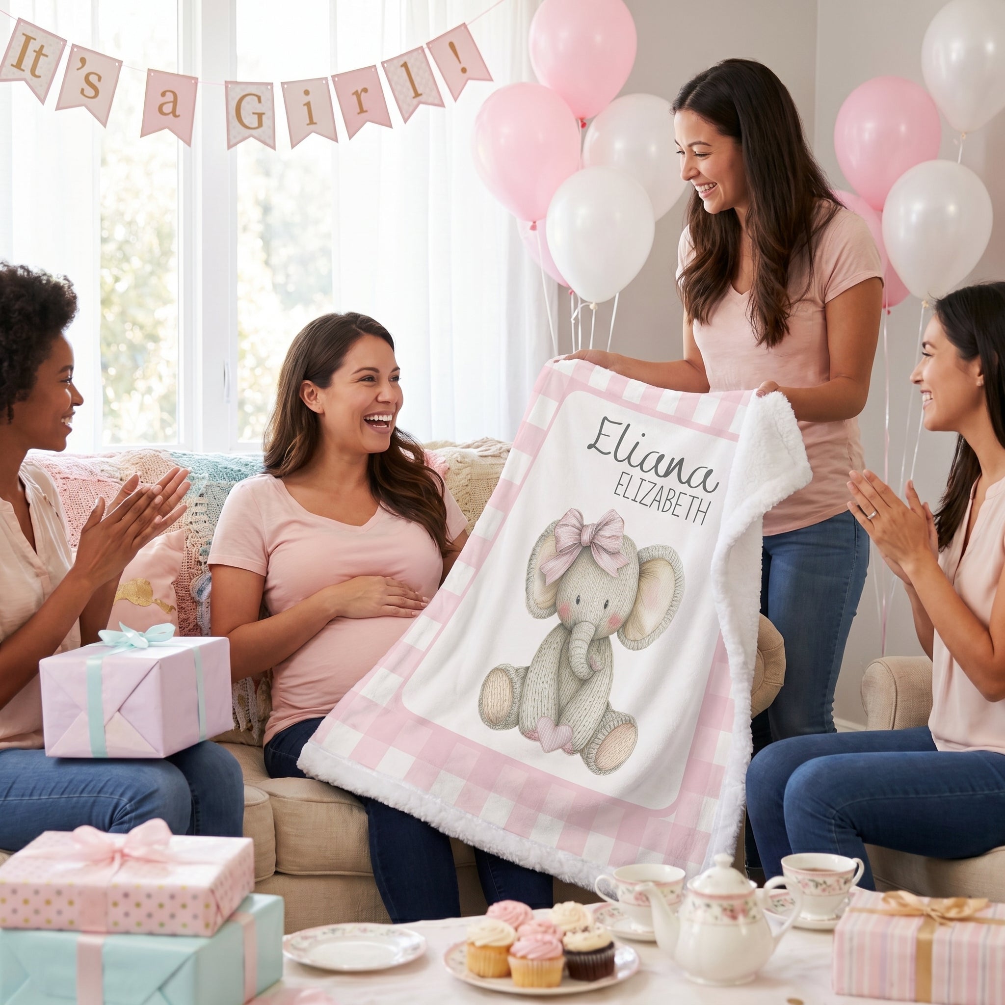 Personalized elephant minky blanket held up at baby shower gift reveal