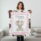 Personalized elephant minky baby blanket with cow print fur backing, held up indoors
