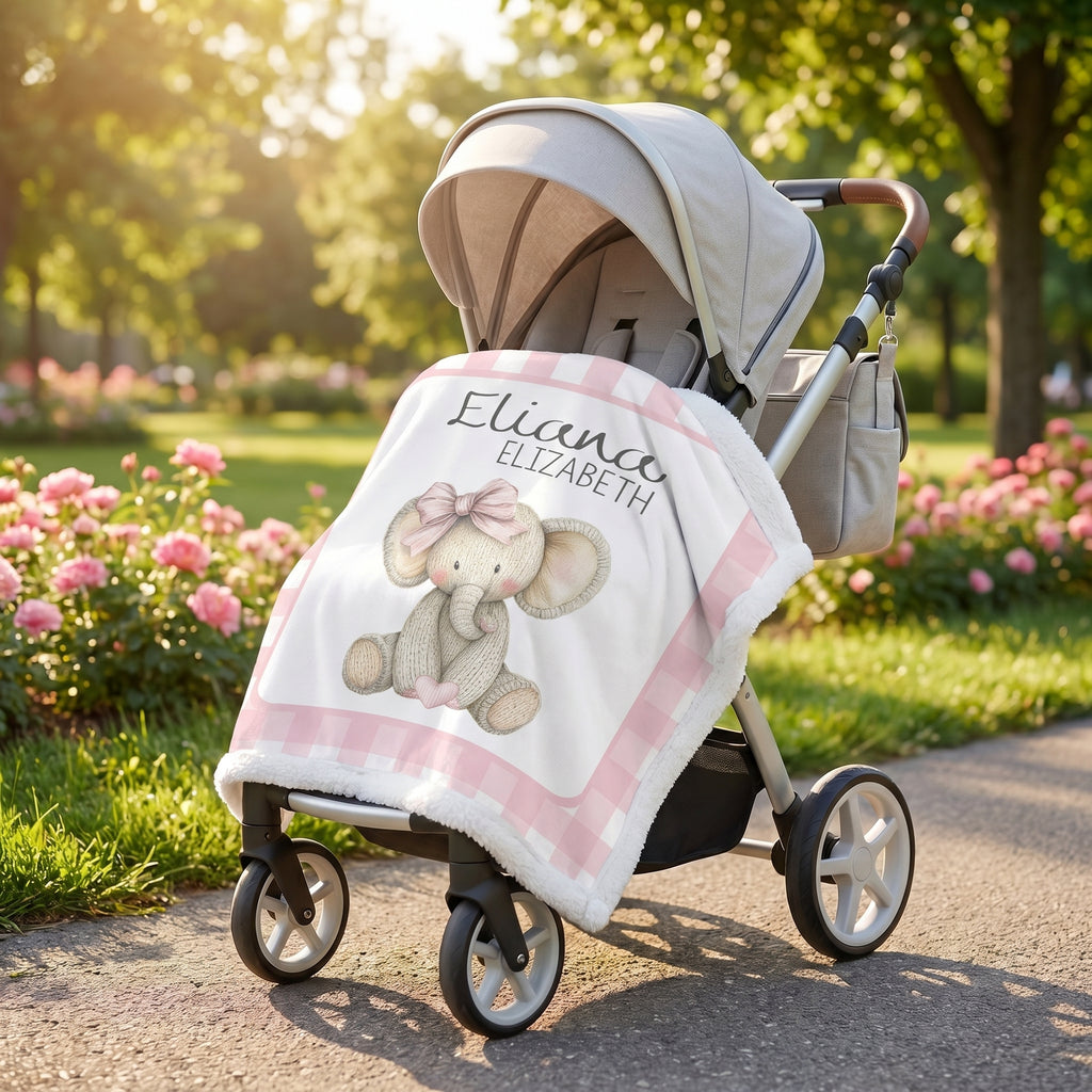 Personalized elephant minky blanket draped over stroller in rose garden