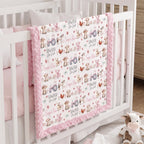Personalized farm animal minky baby blanket draped over crib rail in nursery