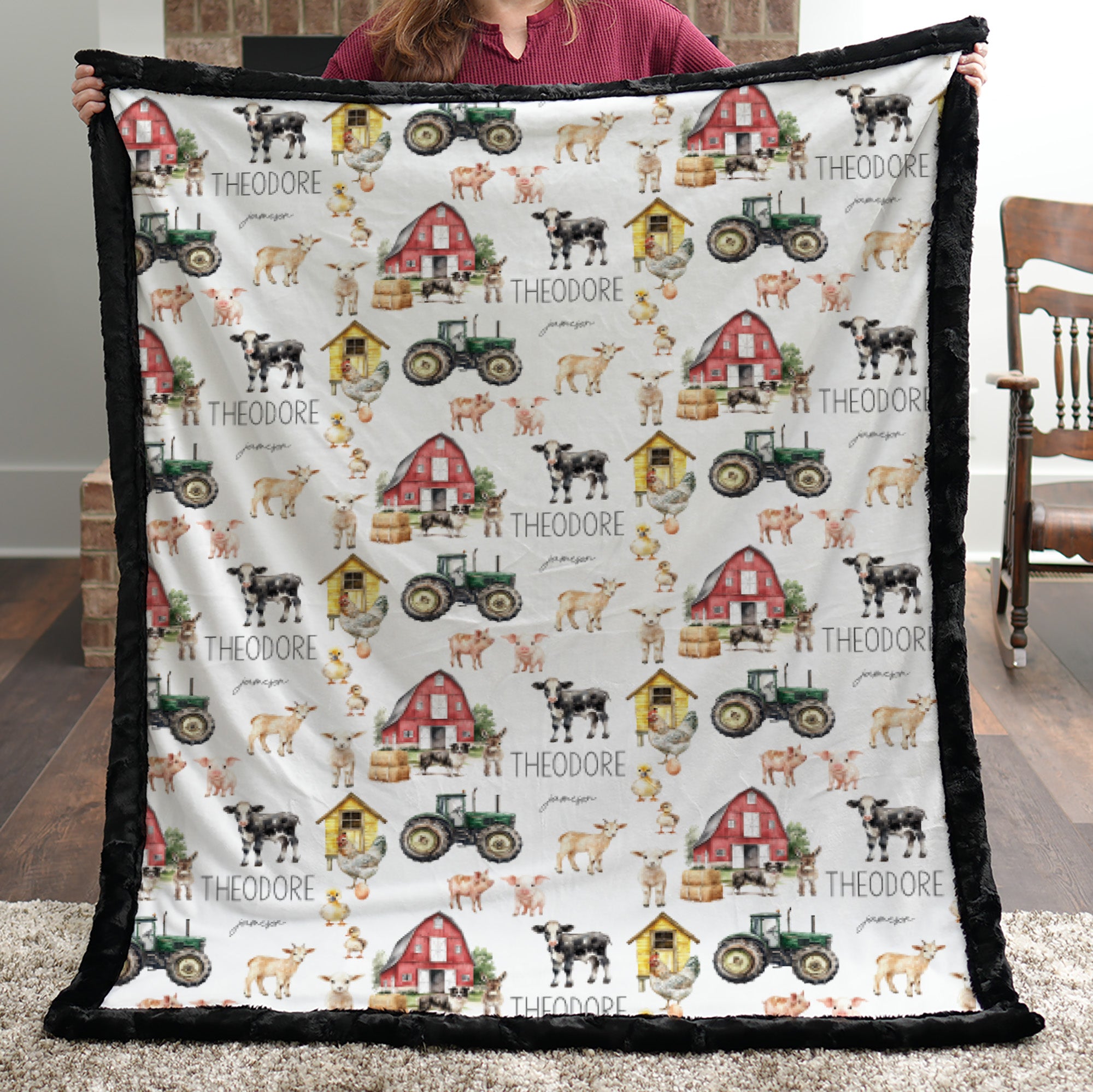 Woman holding personalized farm minky blanket with black trim