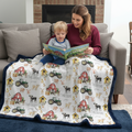 Mother and toddler reading together under personalized farm minky blanket with navy trim