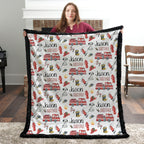 Personalized firefighter baby blanket with black faux fur border, held by woman in front of fireplace