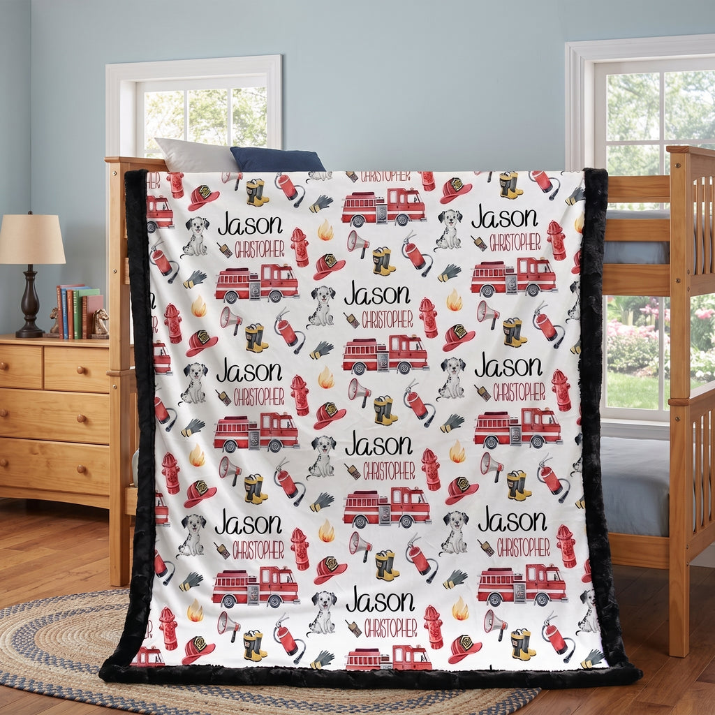 Personalized firefighter minky baby blanket with black faux fur border, draped on bunk bed