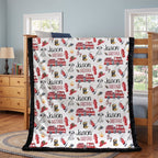 Personalized firefighter minky baby blanket with black faux fur border, draped on bunk bed