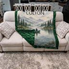Personalized fishing blanket folded on a couch showing the green Luxe Cuddle Minky backing