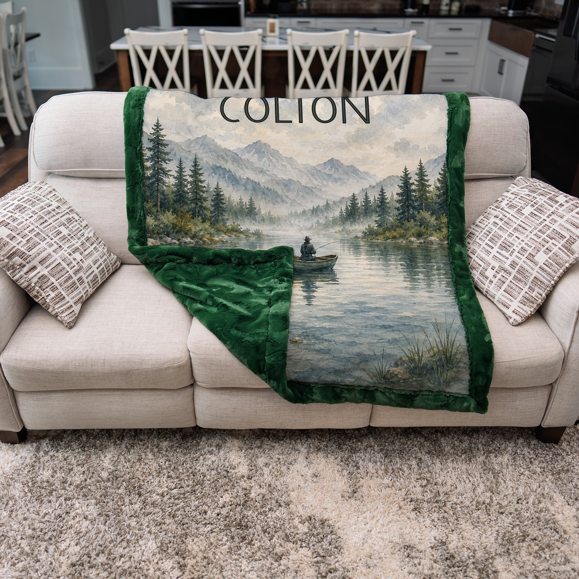 Personalized fishing blanket folded on a couch showing the green Luxe Cuddle Minky backing