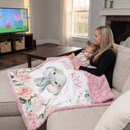 Mom and toddler girl on couch under personalized June Rose floral elephant minky blanket