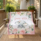 Personalized June Rose floral elephant minky blanket draped over a porch swing