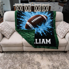 Personalized football blanket folded on couch, showing blue minky front and green minky back