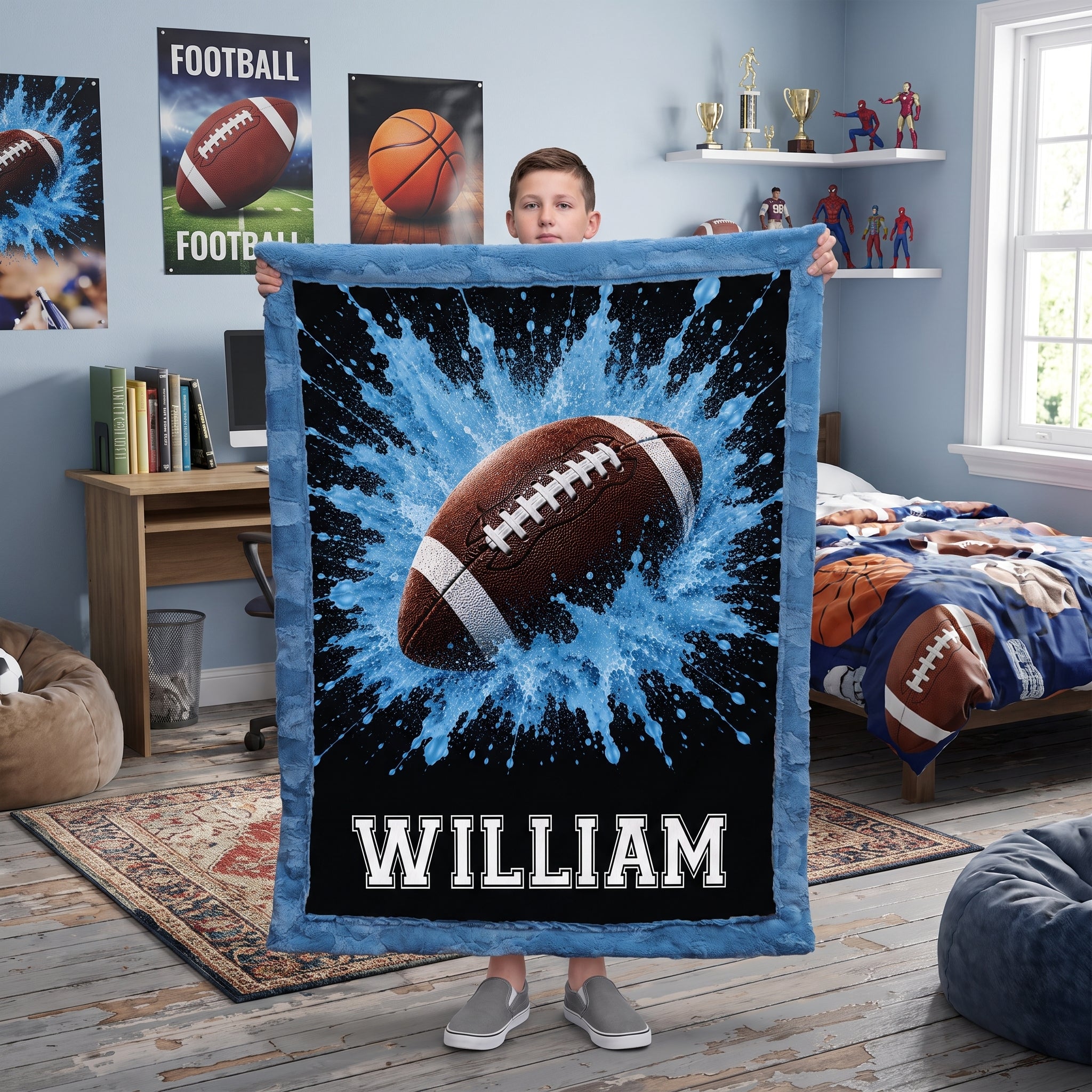 Personalized football minky baby blanket, boy holding it in a football-themed bedroom