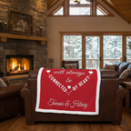 Personalized friends minky blanket with heart design draped over brown leather couch by fireplace